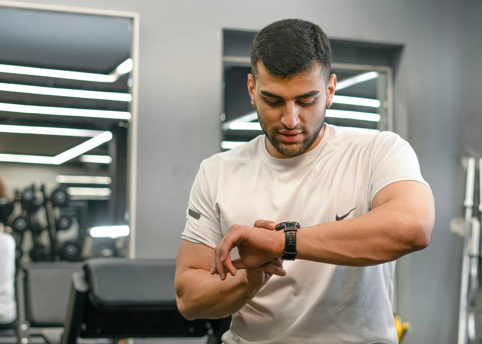 An athlete checking a smartwatch mid-session